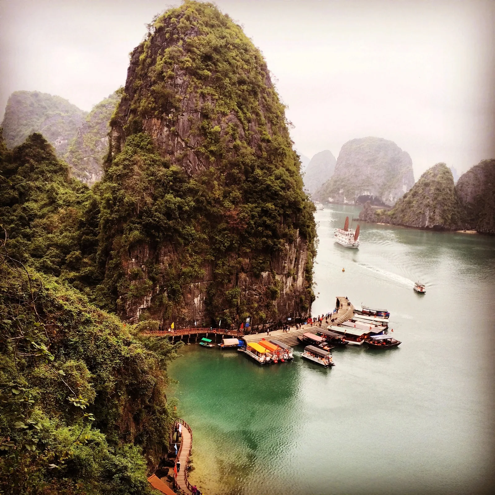 Những núi đá vôi vươn cao trên bến thuyền và vịnh nước xanh ngọc ở vịnh Hạ Long, Quảng Ninh.